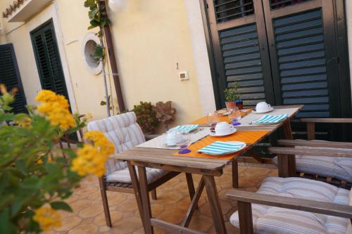 a wooden table and chairs on a patio at Risveglio Ibleo in Ragusa