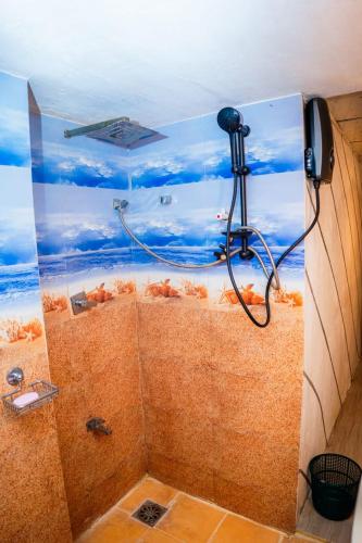 a shower with a fish painting on the ceiling at Ceylon Retreat Villa in Kamburugamuwa