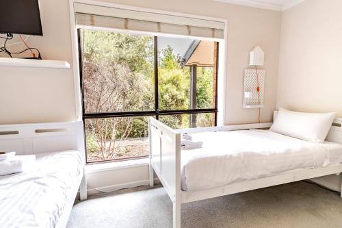 a bedroom with two beds and a window at Cindy's View in Bright