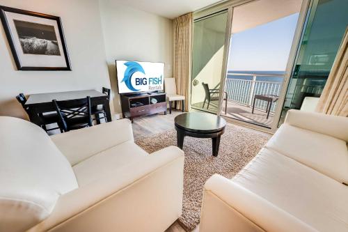 a living room with a white couch and a television at Romantic Honey Moon Suite, Direct Oceanfront,Pools in Myrtle Beach