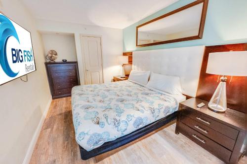 a bedroom with a bed and a mirror on the wall at Romantic Honey Moon Suite, Direct Oceanfront,Pools in Myrtle Beach