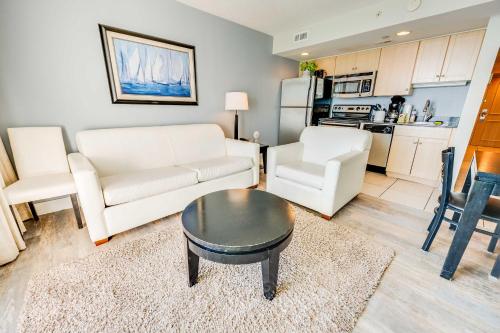 a living room with a couch and a table at Romantic Honey Moon Suite, Direct Oceanfront,Pools in Myrtle Beach