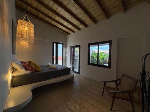 a bedroom with a bed and a chandelier at Bibi in La Trinité