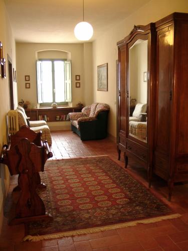 a living room with a couch and a chair at Agriturismo La Capitata in Pian di Scò