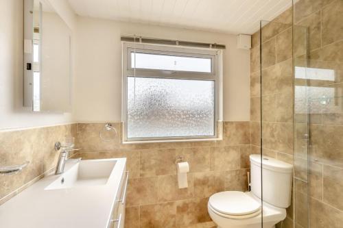 a bathroom with a toilet and a sink and a window at 2 Bed in Wooler oc-l29429 in Wooler
