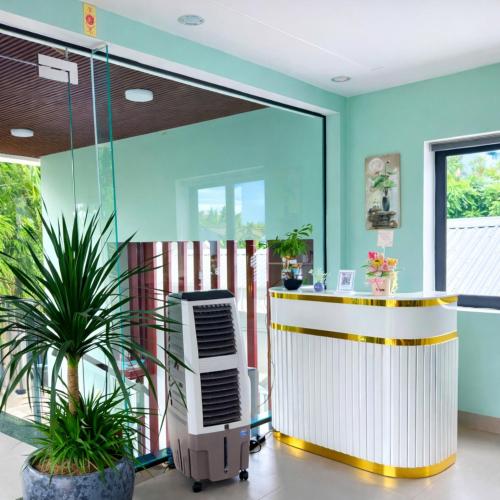 a lobby with a reception desk and a plant at Victoria Hostel Huế in Hue