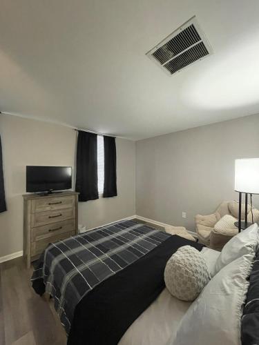 a bedroom with a bed and a flat screen tv at Riverside Retreat in Camden