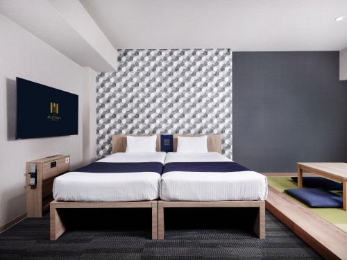a bedroom with a large bed in a room at MONday Apart Ueno Shinokachimachi in Tokyo