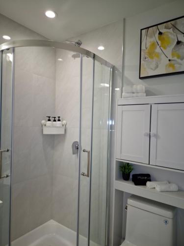 a bathroom with a shower and a toilet at Cozy Private Suite near YVR Airport in Vancouver