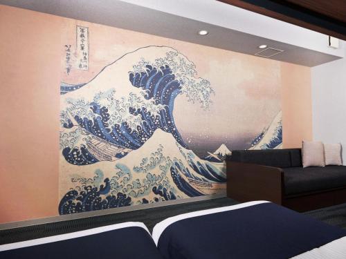 a large painting of the great wave on a wall at MONday Apart Ueno Shinokachimachi in Tokyo