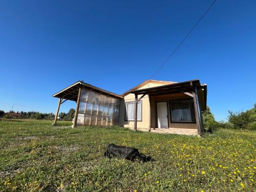 a small house in the middle of a field at Cabañas Campestres Inés in Chillán