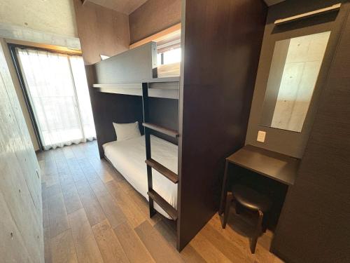 a small room with a bunk bed and a window at Prime Suites Tokyo in Tokyo