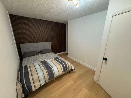 a bedroom with a bed with a brown wall at Private Room With Washroom Near Airport D14 in Mississauga