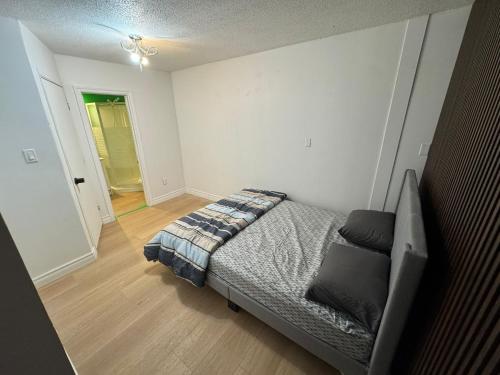 a bedroom with a bed and a hallway at Private Room With Washroom Near Airport D14 in Mississauga