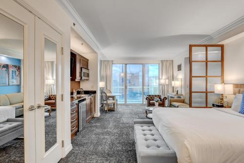 a bedroom with a large bed and a living room at SPHERE VIEW - Signature MGM Resort Lucky Gem Penthouse & Luxury Suites 27817 in Las Vegas