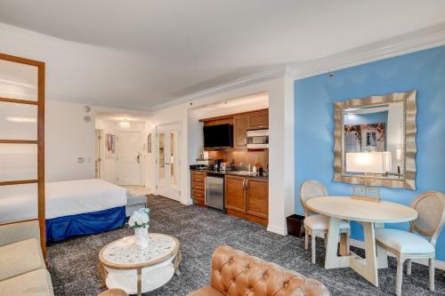 a hotel room with a bed and a table at SPHERE VIEW - Signature MGM Resort Lucky Gem Penthouse & Luxury Suites 27817 in Las Vegas