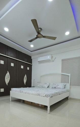 a bedroom with a bed with a ceiling fan at 3bhk Near kodapur-Hitex Exhibition&Shilparamam Art in Hyderabad
