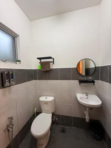 a bathroom with a toilet and a sink at Teratak Shamar in Kampong Tebok Pulai