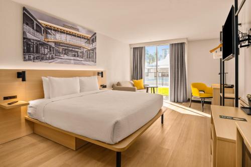 a hotel room with a bed and a desk at B&B HOTEL Orlando International Drive near Universal - Newly Renovated! in Orlando