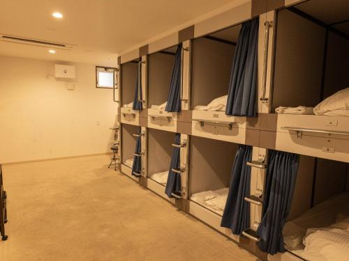 a row of bunk beds in a room at HOTEL PAiKAJi in Ishigaki Island