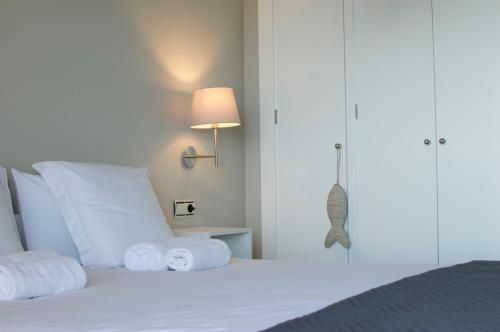 a bedroom with a bed with towels on it at Apartamentos Santa Clara in Calpe