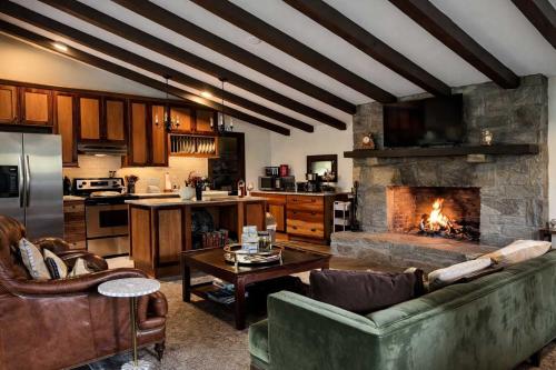 a living room with a couch and a fireplace at Honeymoon Cottage Chateau DuMont in Banner Elk
