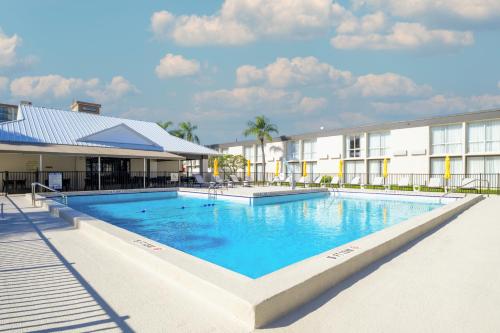 a large swimming pool in front of a building at B&B HOTEL Orlando International Drive near Universal - Newly Renovated! in Orlando