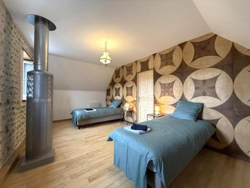 a bedroom with a bed and a wood stove at Lo casalar in Noguères