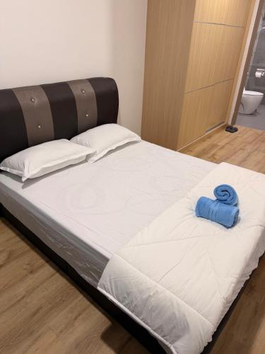 a large bed with a blue ribbon on it at Hann's Residence Your second home in Sibu