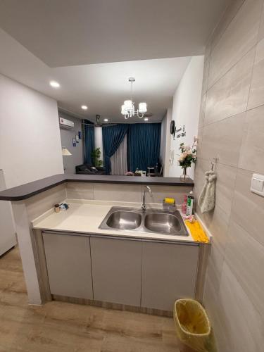 a kitchen with a sink and a mirror at Hann's Residence Your second home in Sibu