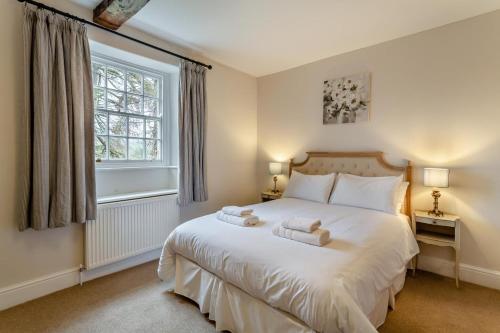 a bedroom with a large white bed and a window at 5 Bed in Wath oc-w28415 in Wath
