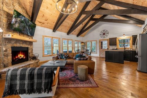 a living room with a couch and a fireplace at Family fun, romantic Hot Tub, Firepit, King Bed 15 min from Blue Ridge & Ellijay in Blue Ridge