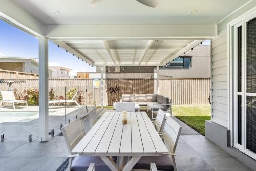 a patio with a white table and chairs at Sunhaven in North Creek