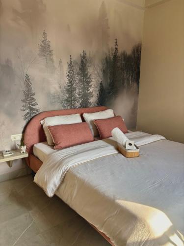 a bedroom with a bed with a painting on the wall at Chèrie Blueleaf in Jaipur