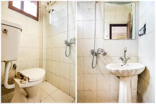 a bathroom with a toilet and a sink at Hotel O by OYO Angad Continental in Ambāla