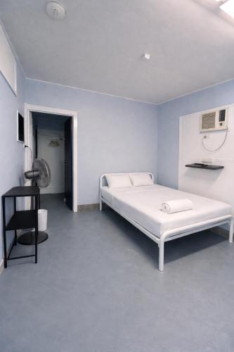 a white bedroom with a white bed in a room at Zen Hostel in Townsville