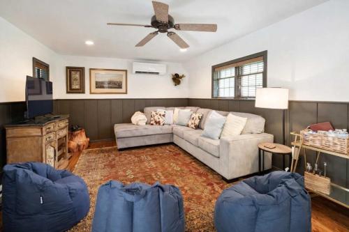a living room with a couch and a ceiling fan at Hideaway Cottage Chateau DuMont in Banner Elk
