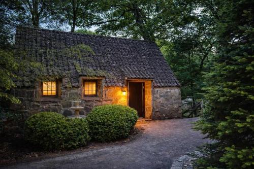 a stone house with a door in the yard at Hideaway Cottage Chateau DuMont in Banner Elk
