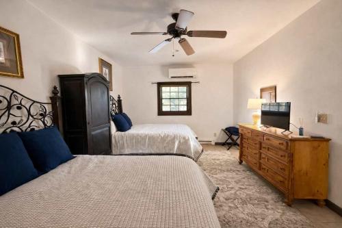 a bedroom with two beds and a ceiling fan at Hideaway Cottage Chateau DuMont in Banner Elk