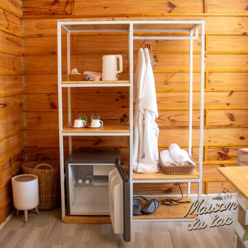 a room with a wooden wall with a shelving unit at Maison Du Lac The Panoramic Glass Lodge in Wang Nam Khieo