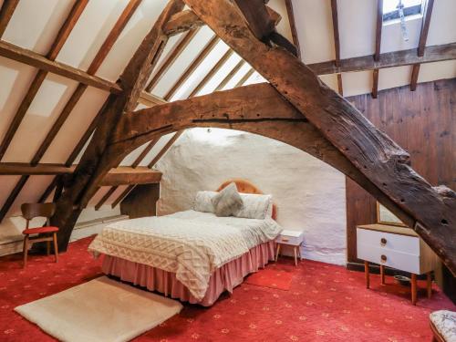 a bedroom with a bed in an attic at Cynfal Fawr in Blaenau-Ffestiniog
