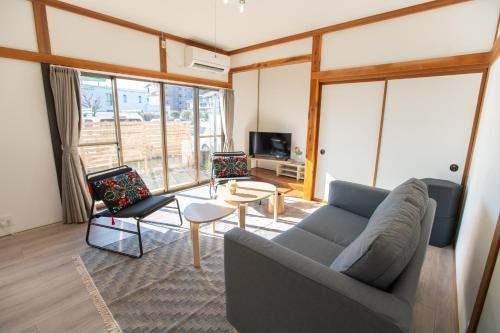 a living room with a couch and a table at Tsugumi Entire House Rental in Matsumoto in Matsumoto