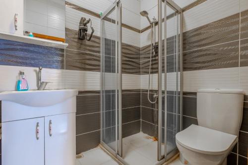 a bathroom with a shower with a toilet and a sink at suites beyazıt in Istanbul