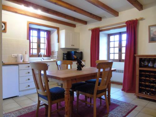a kitchen with a wooden table and chairs at Gîte Chez Marot in Varaignes