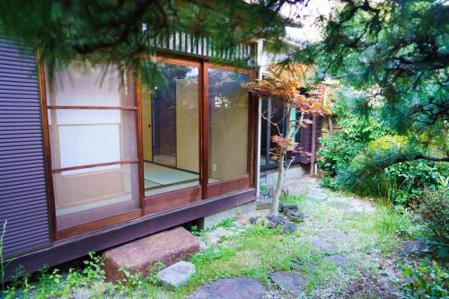 a house with a window on the side of it at 響-Garden House- in Toyonaka