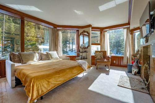 a bedroom with a large bed in a room with windows at Everline Resort & Spa 701 & 703 in Olympic Valley
