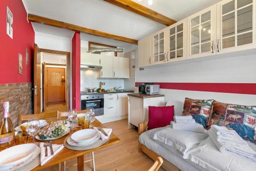 a living room with a couch and a table at Studio Valleverde 26B - Happy Rentals in Sestriere