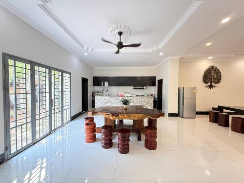a living room with a table and a kitchen at Thida Villa in Siem Reap