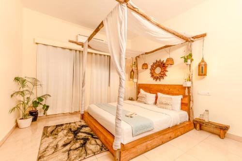 a bedroom with a bed with a canopy at Alaya Stays Luxe FarmAcre Pet-friendly 4-BHK Villa With Private Pool, Garden & Terrace in Gurgaon