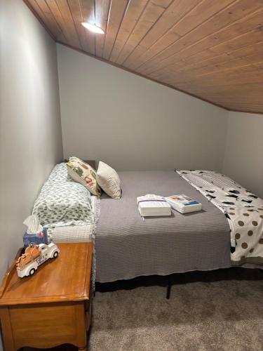 a small bedroom with a bed and a table at The Loft on the Lot in Cambridge